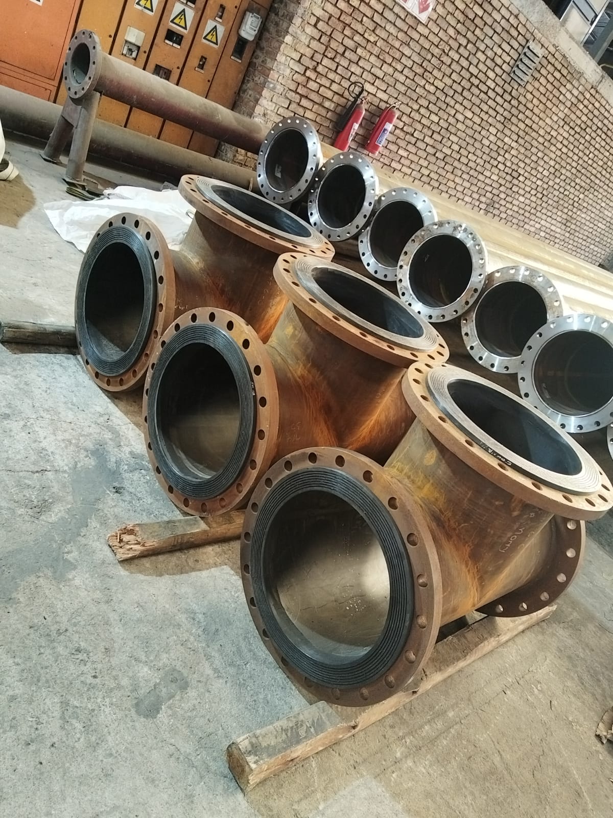 HDPE-lined steel tee fittings with flanged ends in the Wetpipe workshop