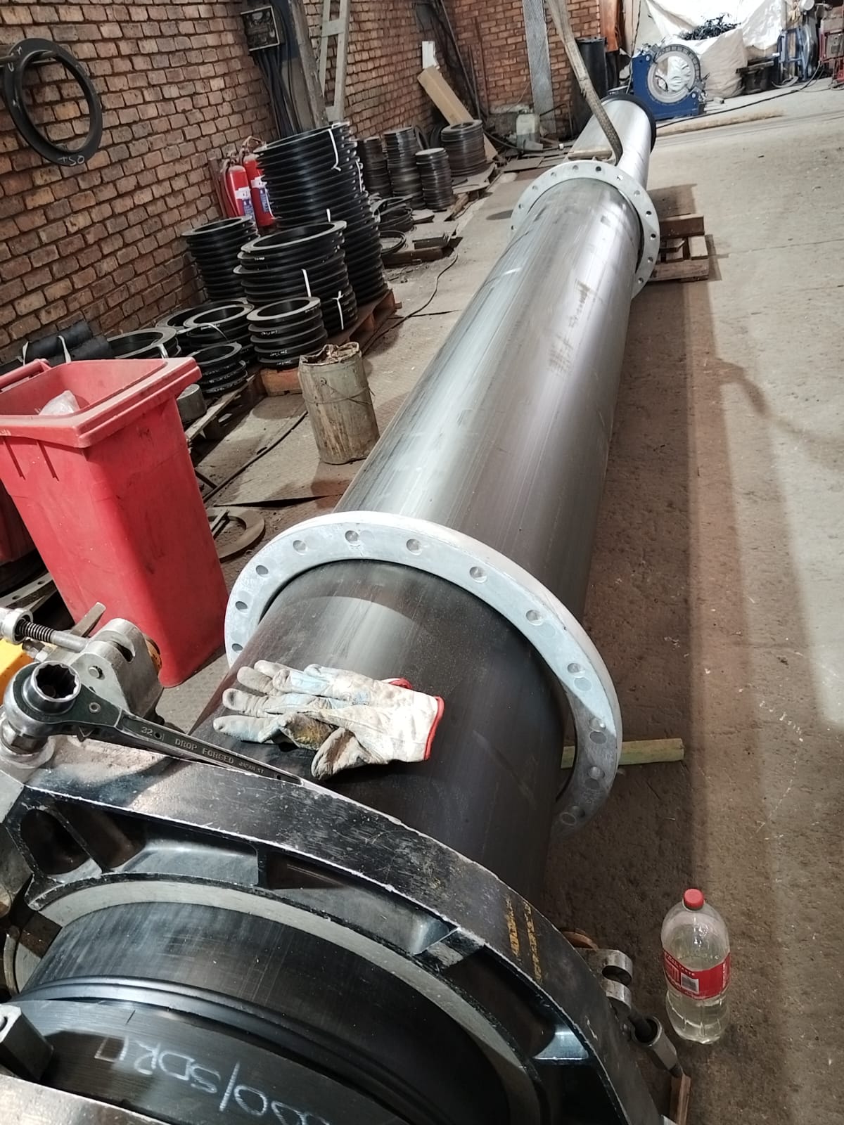 HDPE liner being inserted into a steel slurry pipe in the Wetpipe workshop