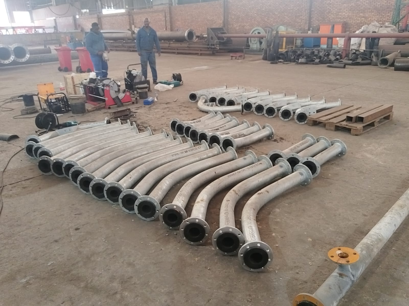 Batch of lined flanged steel slurry bends fabricated in the Wetpipe workshop