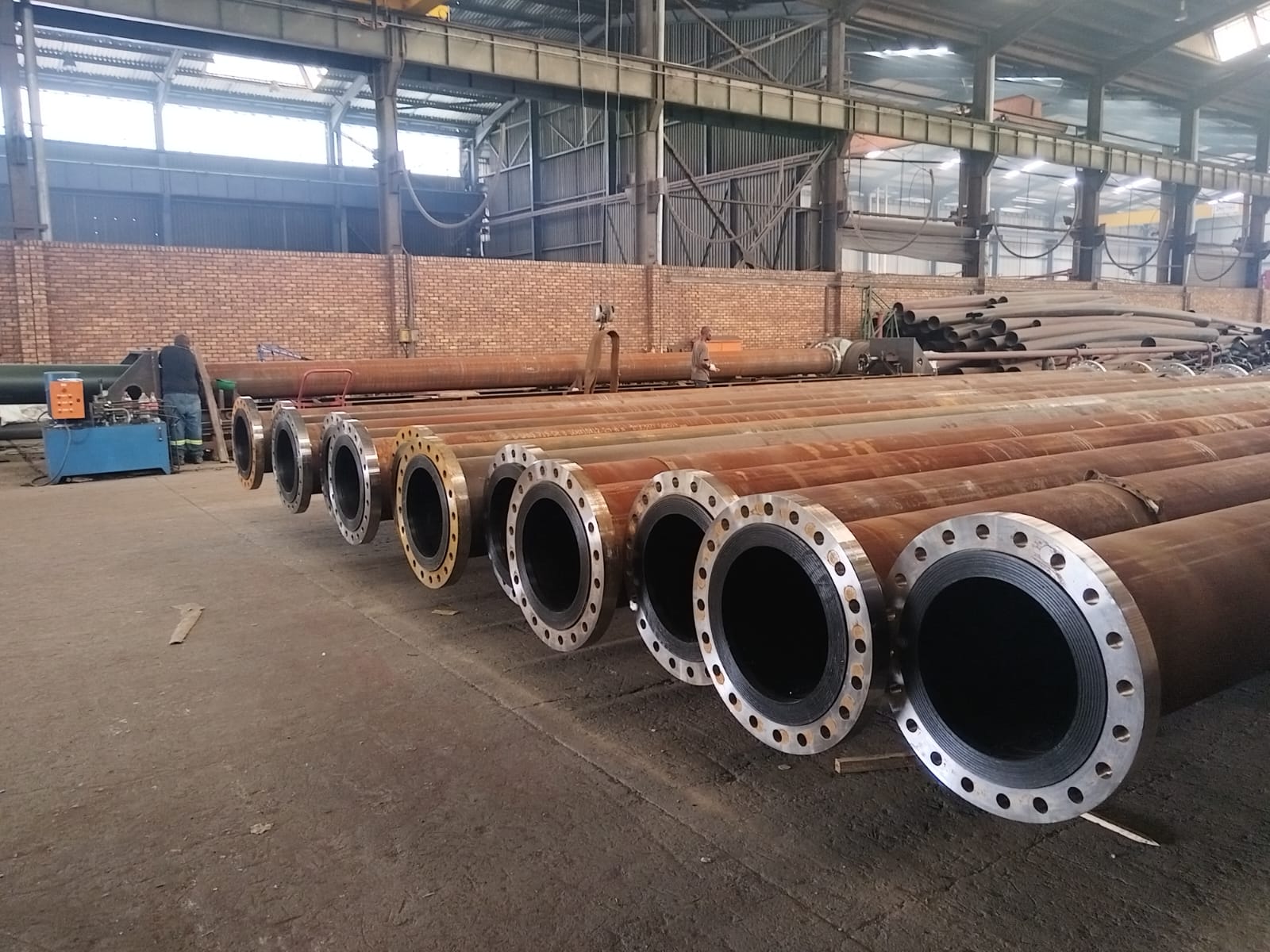 Lined flanged steel slurry pipe spools staged in the Wetpipe fabrication workshop
